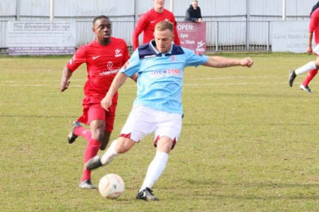 Carshalton Athletic v Hastings United football action - Sam Adams on the ball