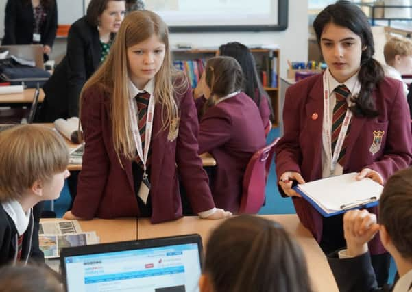 Editors Betty Perceval, 14, right, and Lottie Myers, 12, leading their team of reporters