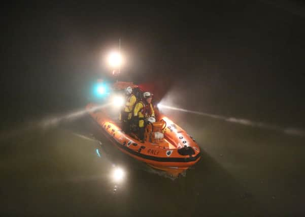 Lifeboat crews conducting a search of the River Arun last night following reports of a person jumping into the river. PHOTO: Eddie Mitchell