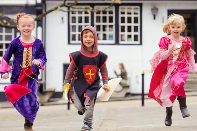 (l-r) Rosie Waterhouse (8), Ewan Willis (4) and Ella Waterhouse (6).   Medieval Midhurst festival, Market Square, Midhurst.  Picture by Allan Hutchings