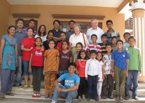 Ram Rijai (front centre) in front of Bloom Nepal, the school he founded SUS-151105-151619001