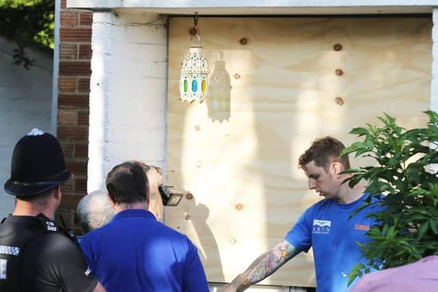 Council workers board up the front door of 31, Ash Grove, Bognor Regis. Picture by Eddie Mitchell