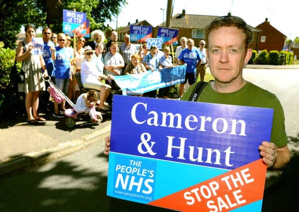 Mick Duncan and local residents protesting NHS out of TTIP in Horsham. Pic Steve Robards SR1514915 SUS-150630-135241001