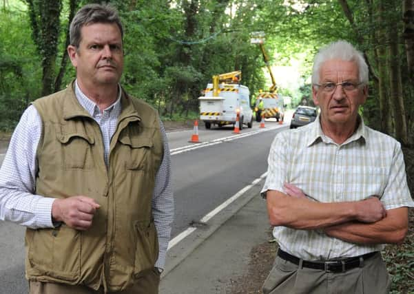 Peter Miles and Jim Ray (Vice Chairman of Mountfied Parish Council) pictured on the A2100. In the background, engineering works are going on to restore phone and internet connections to the village. SUS-150807-134809001