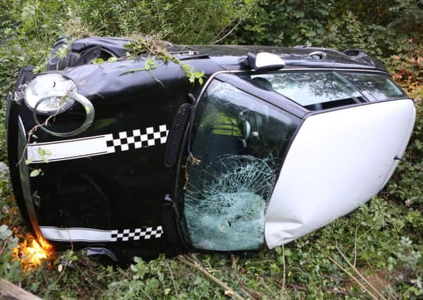 The Mini overturned at 8.45pm on the A27 at Lancing on Monday night. PICTURES BY EDDIE MITCHELL