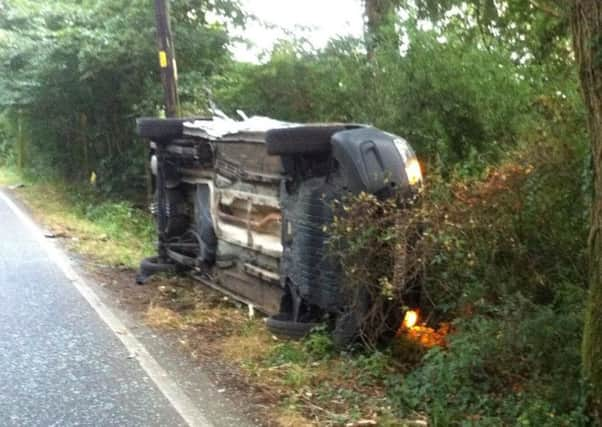 Car on its side after two car collision in Goose Green Lane, Thakeham. Photo by Nil Worth and Sussex West Road Policing Unit