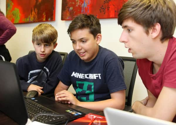 DM1520143a.jpg Festival of Code. L to R Aidan 12, Jonathan 12 and mentor Nick Jackson. Photo by Derek Martin SUS-150728-155122008