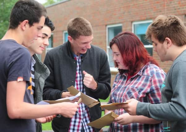 Students from Angmering school compare grades.ks1500369-4 SUS-150813-152200008