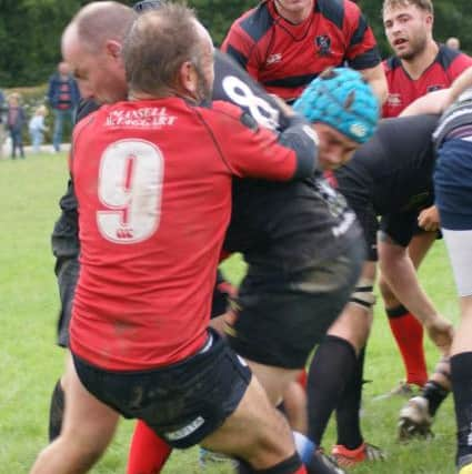 Heath veteran scrum half Alex Meredith tackles former Heath player Dave Wattam