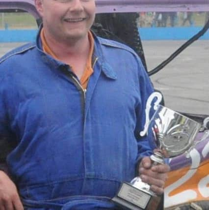 Tim James (right) adds another winners trophy to his cabinet