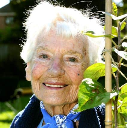 Jan Whittle with a tree planted in memory of her husband Leonard SR1522319