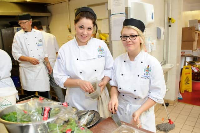 Daisy Madgwick and Hannah Perry prepare the food in the kitchen as 

students from Chichester College host the second of three special lunches at Brookfield Hotel, Emsworth 

Picture: Allan Hutchings