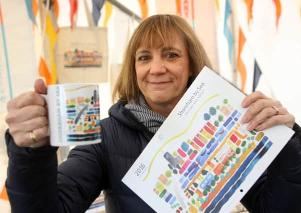 Kim-Adele Fuller, adurArtcollective chairman, with the calendar and the mug featuring Karen Muncks picture DM15222024a