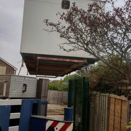 The cabin is lowered into place at the East Beach Evangelical Church, in Selsey. Picture by Phil Harding