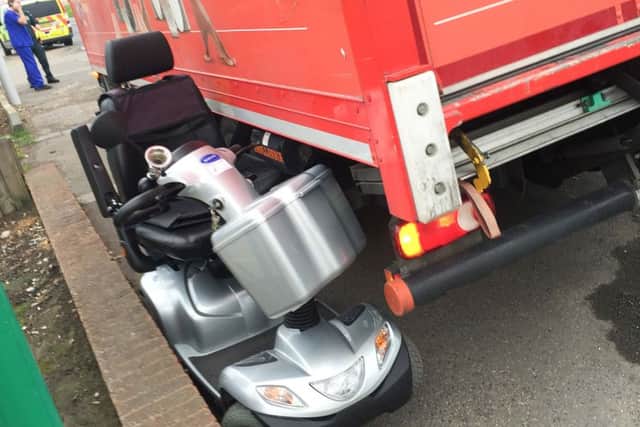 The scooter's arm rest became wedged under the lorry