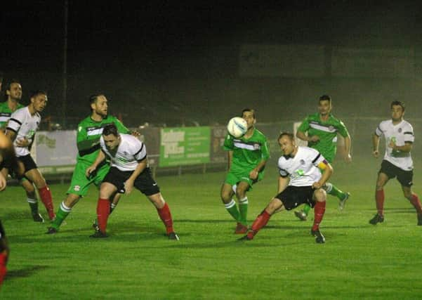 Horsham YMCA attack the Crawley Down Gatwick defence. Photo by Clive Turner