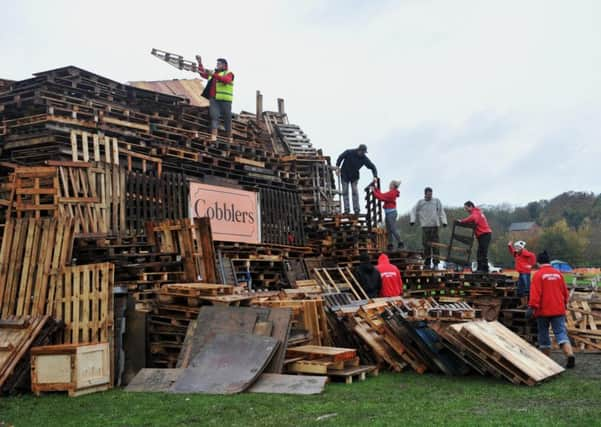 Members of Waterloo Bonfire Society prepare their huge bonfire at the Lewes Bonfire Celebrations 2015 Photograph taken by Simon Dack SUS-150511-115052001