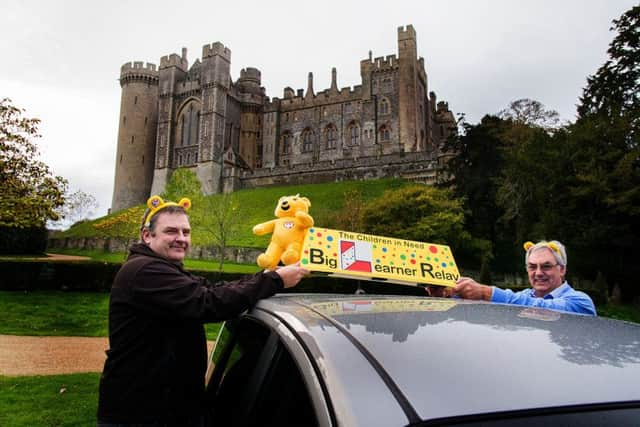 Steve Pearce, left, hands the roof box over to David Lancaster at Arundel Castle