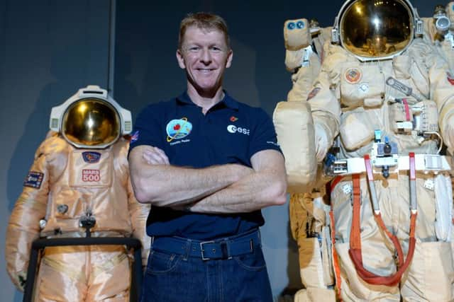 British astronaut Tim Peake poses beside spacesuits as he talks to UK media at the Science Museum, London, before being launched into space Picture by Anthony Devlin/PA Wire