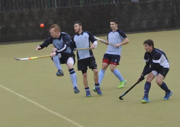 Tudor Stainsby takes a painful blow during South Saxons' victory over Hailsham on Saturday. Picture by Simon Newstead (SUS-151115-224553002)