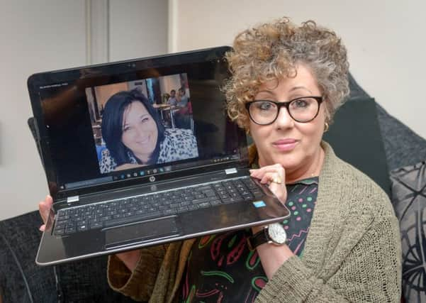 Bev Fletcher pictured holding a picture of her daughter Kim.