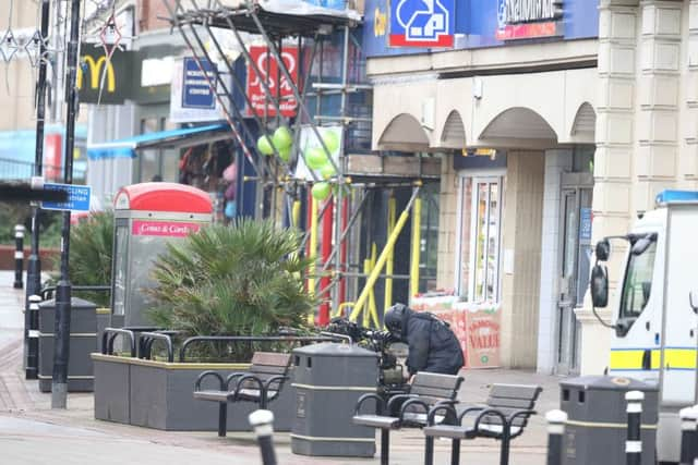 The EOD getting ready to inspect the package in McDonalds. Photo by Eddie Mitchell