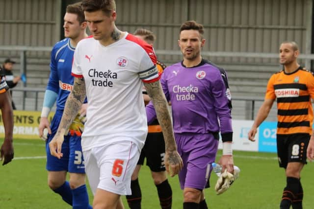 Crawley Town players Sonny Bradley and Darryl Flahavan walk off the pitch at the end of their 4-2 defeat at Barnet SUS-151221-112538002