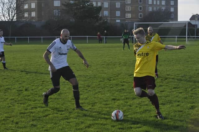 Bexhill United manager Marc Munday closes down Little Common midfielder Liam Foster. Picture by Simon Newstead (SUS-151228-212241002)