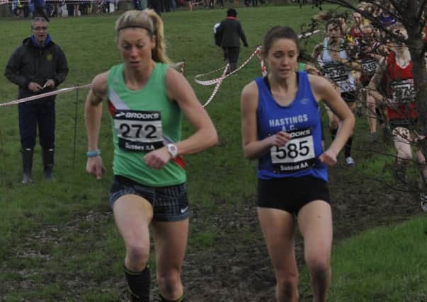 Grace Baker (blue vest) and Emma Macready (green vest) battle it out at the head of the senior/under-20 women's race. Picture by Simon Newstead (SUS-161001-232324002)