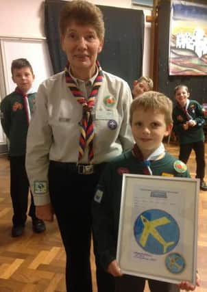 Alfie Jones with his Akela, Wendy Morris, and his winning Air Scouts 75th anniversary badge design