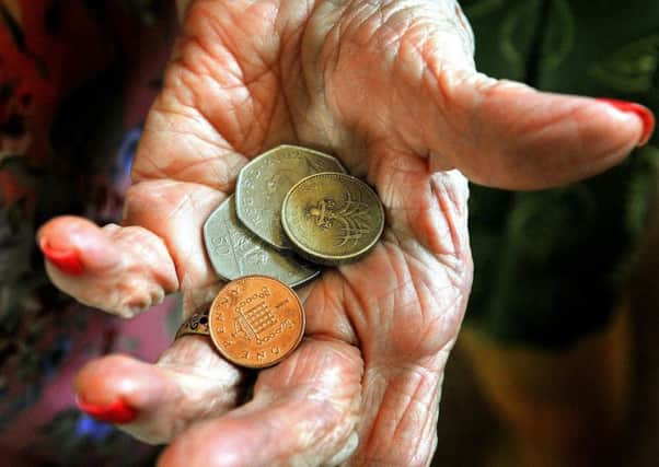 File photo dated 18/10/08 of an elderly person with loose change. During the Chancellor of the Exchequer George Osborne's spending review statement he announced that the universal benefits for pensioners will be retained exactly as budgeted for by the previous government and the temporary increase in the Cold Weather Payment will be made permanent. PRESS ASSOCIATION Photo. Issue date: Wednesday October 20, 2010. See PA story POLITICS CSR. Photo credit should read: John Stillwell/PA Wire 78