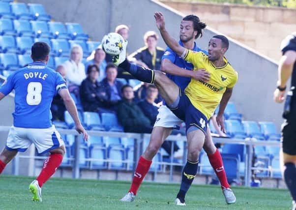 Christian Burgess battles with Oxford's Kemar Roofe earlier in the season Picture: Joe Pepler