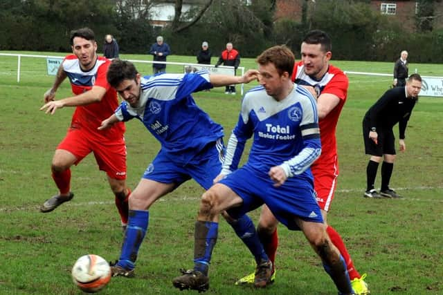 Matt Masson and Sean Dummer (in blue) vie for possession for Midhurst against Heath / Picture by Kate Shemilt