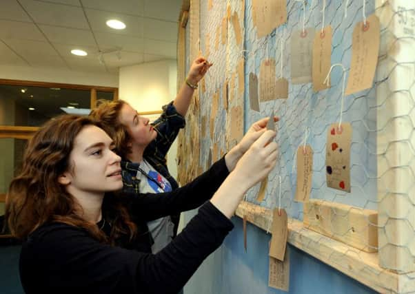 Organisers Claudia Aspinall-Nessling and Meerabai Kings pinning up luggage labels. Pictures: Kate Shemilt ks1600021-1