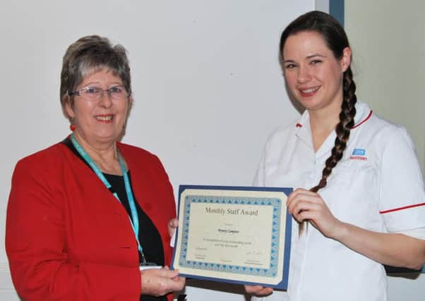 Bryony Campion receiving her award by non-executive director Sue Bernhauser. SUS-160128-144922001