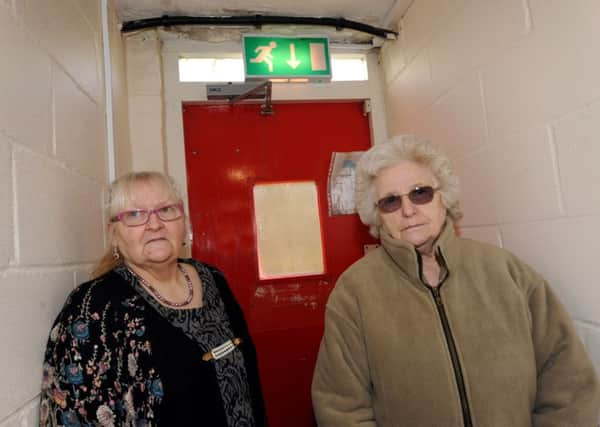 Mary Hawk and Elizabeth Killick in front of the door