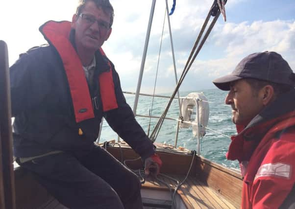 Cornelis and Spencer on his Morgan Giles 30 yacht