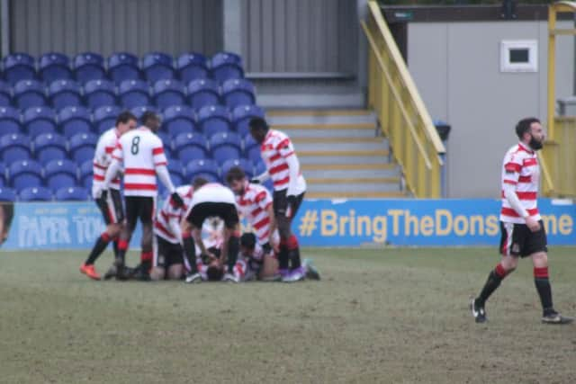 Kingstonian players celebrate their winner