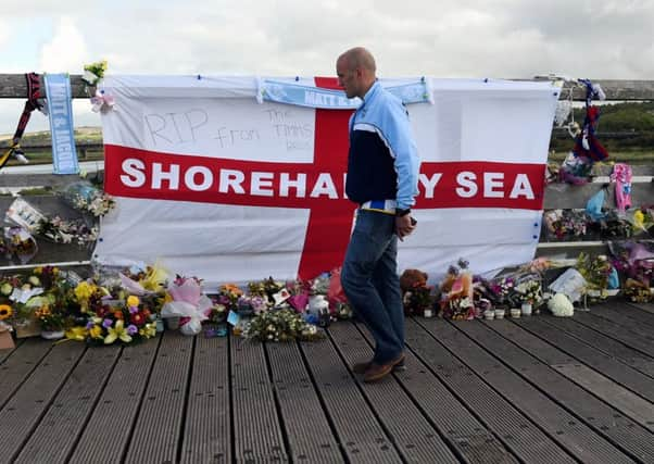 Flowers on Shoreham's Old Toll Bridge in tribute to the 11 who lost their lives last year