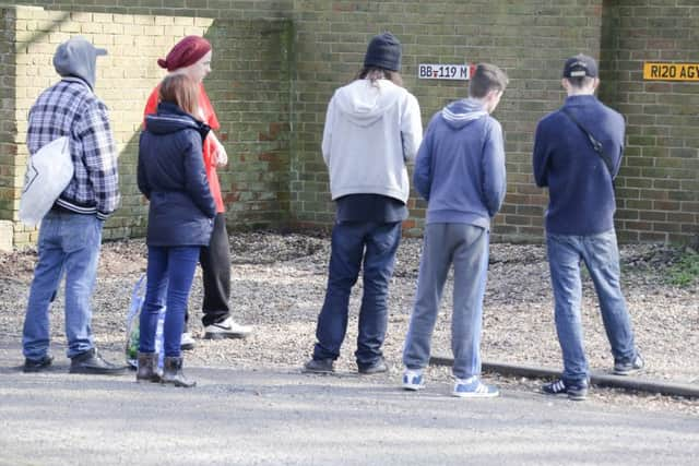 Friends gather at the scene. Photo by Eddie Mitchell