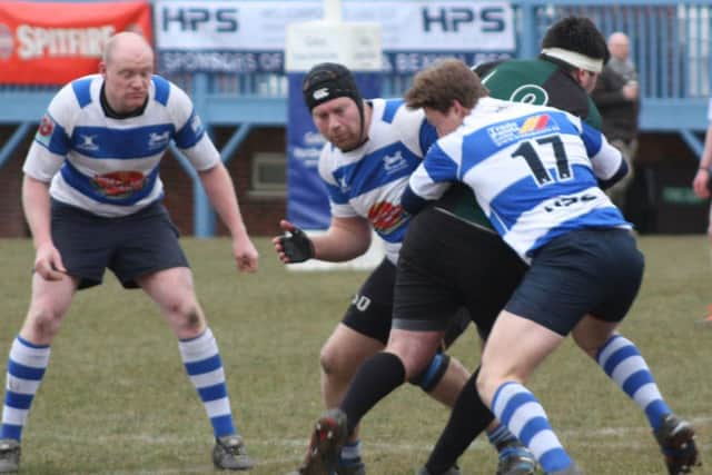 Two Hastings & Bexhill players wrap up a New Ash Green opponent. Picture courtesy Karen Walker