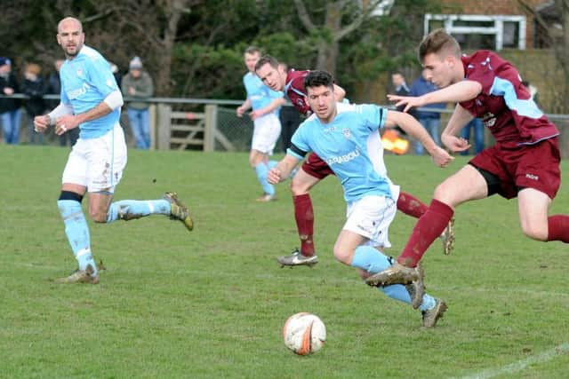 Little Common wide player Nick Richardson takes to the air with Bexhill United full-back Aaron Tudor in close attendance. Picture courtesy Jon Smalldon