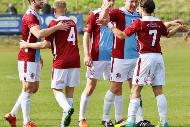 Billy Medlock is congratulated after scoring one of his five goals for Hastings United against Peacehaven & Telscombe. Picture courtesy Joe Knight