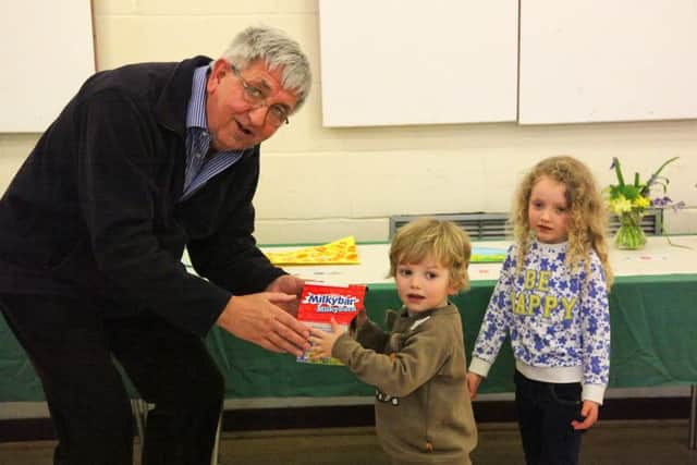 Chairman Charles Ashby presents prizes to William and Beatrix Warren