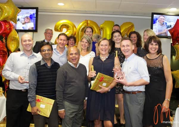 The A&E team celebrating winning an award in 2014