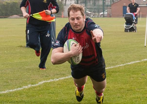 Luke Peters crosses the line for United Services. Picture: Keith Woodland