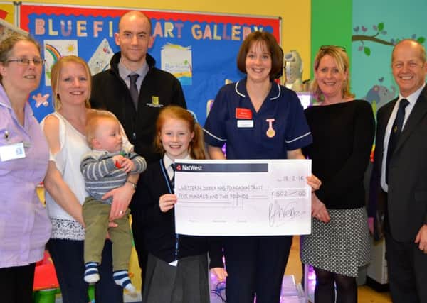 Nurse in charge Becky Holcroft receives the cheque from Electronic Temperature Instruments