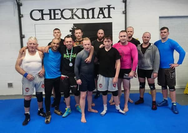 Wrestler John Capstick with coaches and team-mates