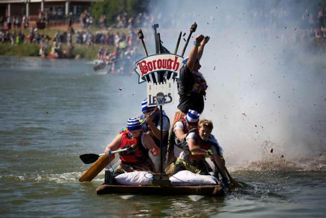 Borough Bonfire Society win the inaugural Bonfire Dash trophy on the river Ouse in Lewes, East Sussex, Sun 19th July 2015. The first regatta in the town for 105 years saw 21 rafts, 20 canoes, 20 boat and four Bonfire Societies battle for new trophies commissioned to mark the 40th annual Lewes to Newhaven charity raft race. SUS-160413-103459001