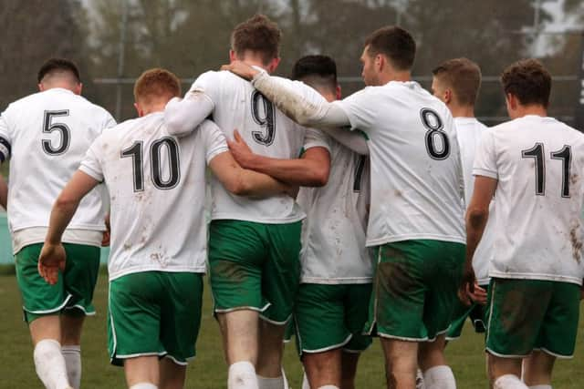 Chichester players celebrate with No9 Jimmy Wild after he scores City's second goal in their 4-0 win over Newhaven / Picture by Chris Hatton